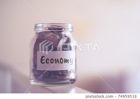 Money economy concept - glass jar with coins. 74959518