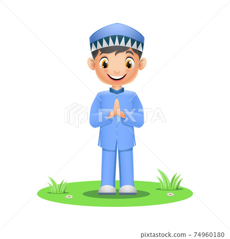 Cute Muslim boy standing on grass 74960180