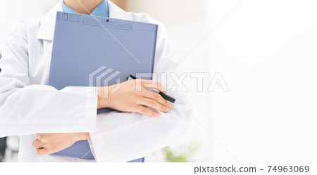 Medical image A woman in a white coat with a medical record 74963069