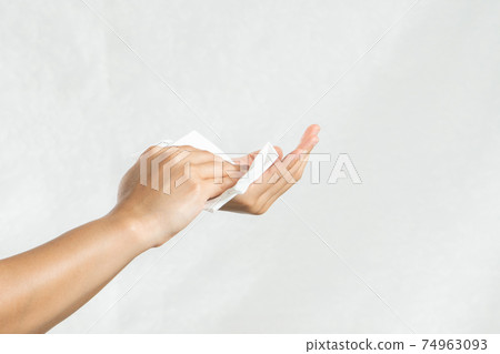 Woman cleaning her hands with white soft tissue paper. isolated on a white backgrounds 74963093