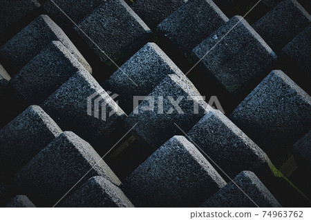 Concrete blocks that are lined up regularly. Coastal scenery with wave-dissipating blocks. 74963762