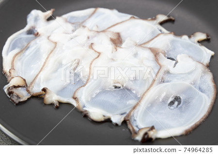 Delicious octopus sashimi on a black plate 74964285