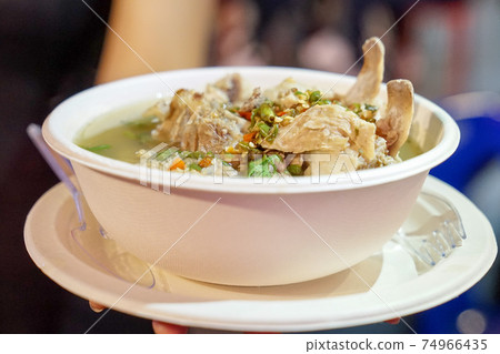 Sour spicy pork spare rib soup, Thai soup style from foodtruck shop at foodstreet, Bangkok, Thailand. 74966435