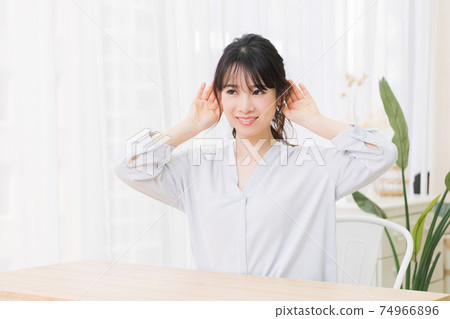 Young woman listening in the room 74966896