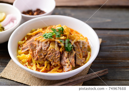 Northern Thai food (Khao Soi), Spicy curry noodles soup with beef Northern Thai food (Khao Soi), Spicy curry noodles soup with beef 74967688