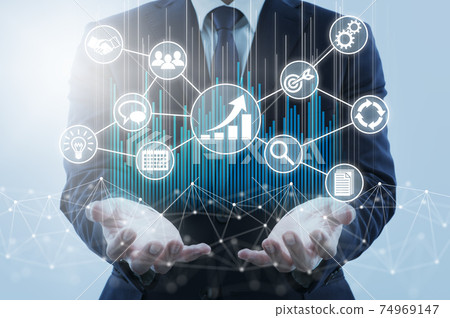 Business growth strategy and management. A man holding his hand over the network structure and business icons. 74969147