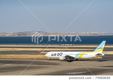 Airport scenery: Taxiing airplane and Tokyo Gate Bridge, Ota-ku, Tokyo 74969680