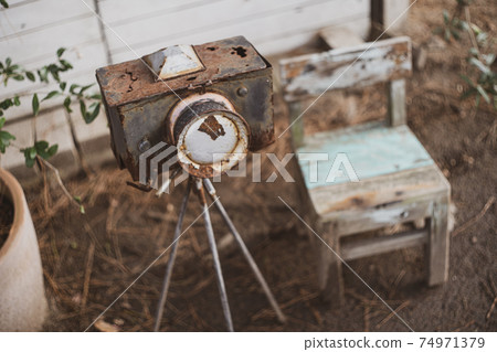 Antique / retro camera objects and small wooden chairs 74971379