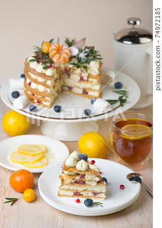 Lemon cakes, pies with a cup of tea on gray background. Top view. Copy space. Cafe menu. Spring mood 74972185