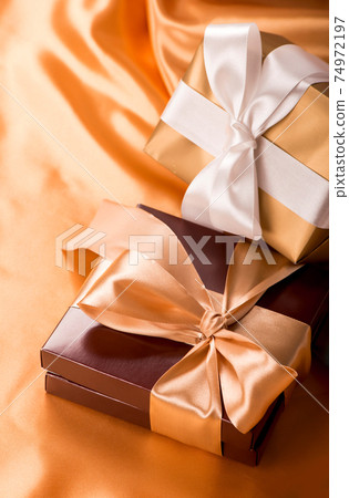 sweet surprise, nice gift - brown box with candies and golden tape 74972197