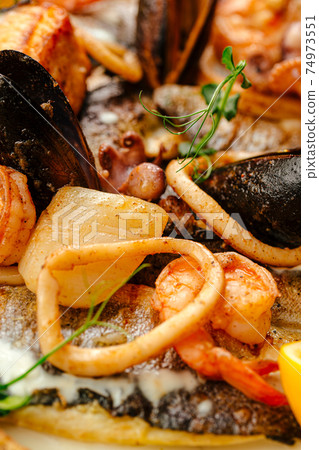 Closeup on seafood saute mix with cream sauce 74973551