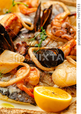 Closeup on seafood saute mix with cream sauce 74973553