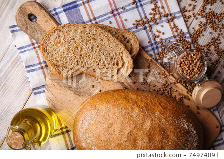 Sliced buckwheat bread on the wooden cutting board 74974091