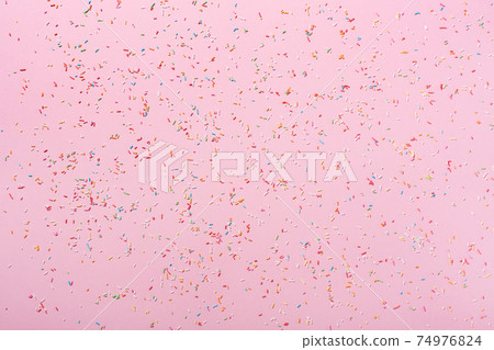 Happy birthday or party background. Flat lay composition with sweet colorful sprinkles on pink paper background. 74976824