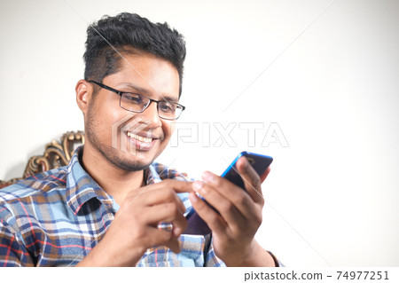 happy young man hand using smart phone. happy young man hand using smart phone. 74977251