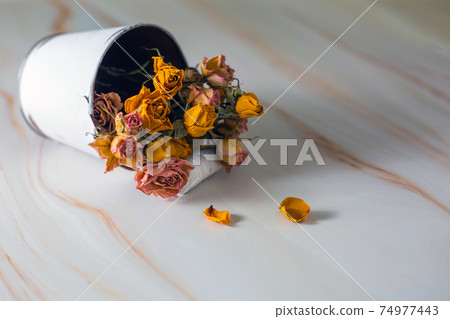 Dried rose flowers in a bucket 74977443