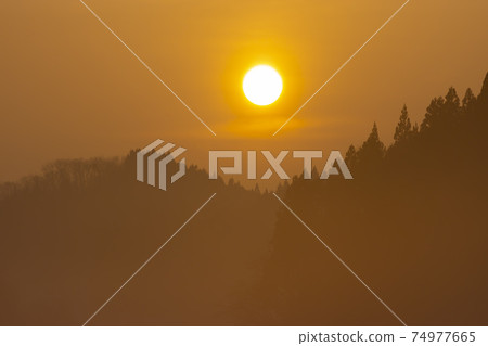 Cold winter sunset and haze Cold winter sunset and haze 74977665