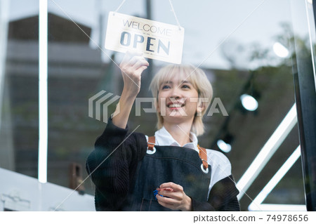 Lovely Asian beauty salon barber young girl hold banner of open the shop with smiling 74978656