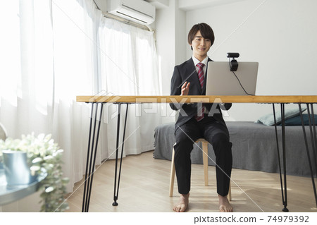 Image of a young male video chat online interview talking to a webcam Image of a young male video chat online interview talking to a webcam 74979392