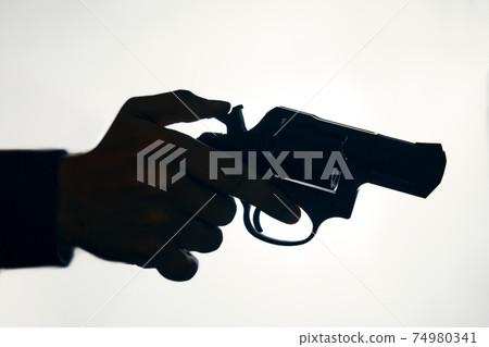 Silhouette of man's hand with revolver on white background. Silhouette of man's hand with revolver on white background. 74980341