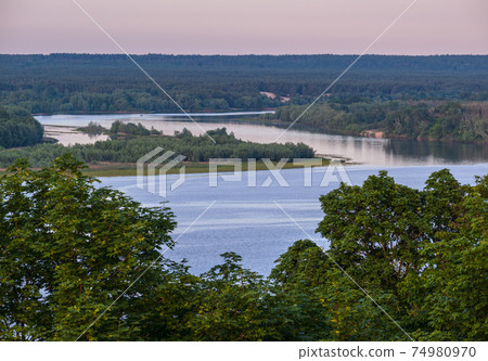 Dnipro river summer evening view from Taras Hill or Chernecha Hora (Monk Hill - important landmark of the Taras Shevchenko National Preserve, Kaniv, Cherkasy Region, Ukraine. Dnipro river summer evening view from Taras Hill or Chernecha Hora (Monk Hill - important landmark of the Taras Shevchenko National Preserve, Kaniv, Cherkasy Region, Ukraine. 74980970