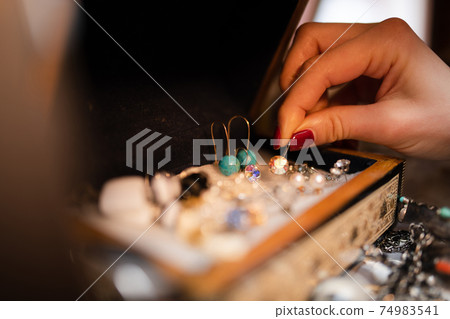 Women's hands choosing accessories 74983541