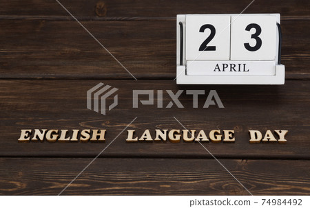 April 23, date on the calendar. English Language Day. Handmade wood cube with date month and day. english alphabet. 74984492