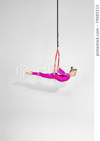 Girl gymnast shows an acrobatic performance Girl gymnast shows an acrobatic performance 74985515