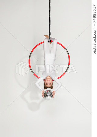 Girl gymnast shows an acrobatic performance Girl gymnast shows an acrobatic performance 74985517