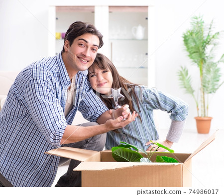 Young family moving in to new apartment after paying off mortgag 74986017