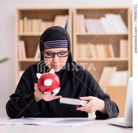 Muslim girl in hijab studying preparing for exams Muslim girl in hijab studying preparing for exams 74986351