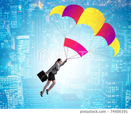 Businesswoman flying on parachute in business concept Businesswoman flying on parachute in business concept 74986391