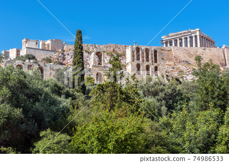 Acropolis of Athens, Greece. Scenic view of Herodes Odeon and Parthenon temple. 74986533