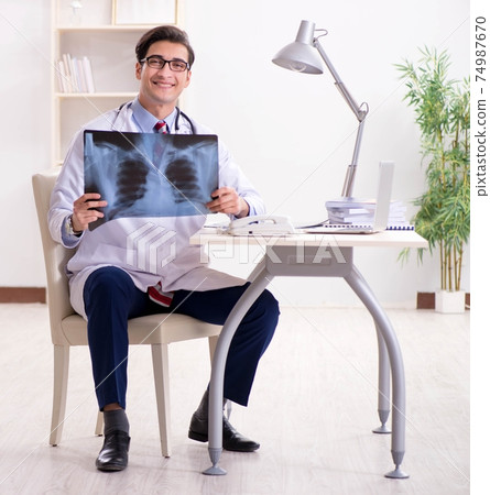 Young handsome doctor working in hospital room Young handsome doctor working in hospital room 74987670