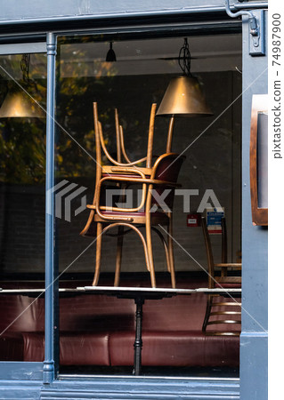 Window of an empty restaurant forced to close amid COVID-19 pandemic Window of an empty restaurant forced to close amid COVID-19 pandemic 74987900