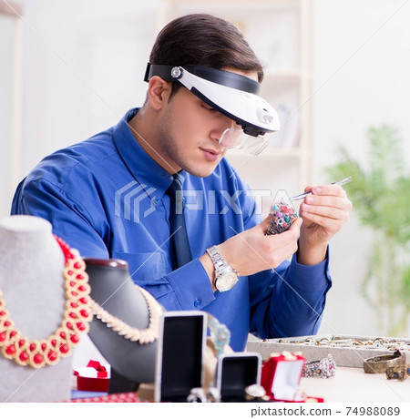 Jeweler working with luxury jewelry in the workshop Jeweler working with luxury jewelry in the workshop 74988089