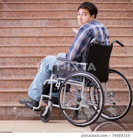 Disabled man on wheelchair having trouble with stairs Disabled man on wheelchair having trouble with stairs 74988119