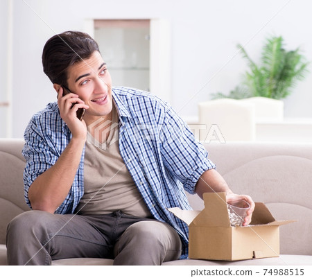 Man receiving parcel at home Man receiving parcel at home 74988515