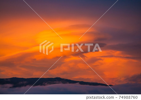 Sunset clouds and mountains Sunset clouds and mountains 74988760