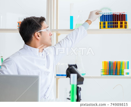 Male chemist working in lab 74989815