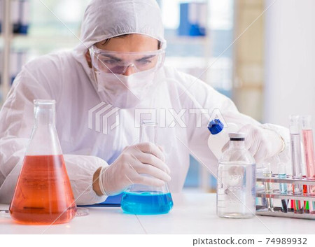 Chemist working in the laboratory with hazardous chemicals Chemist working in the laboratory with hazardous chemicals 74989932