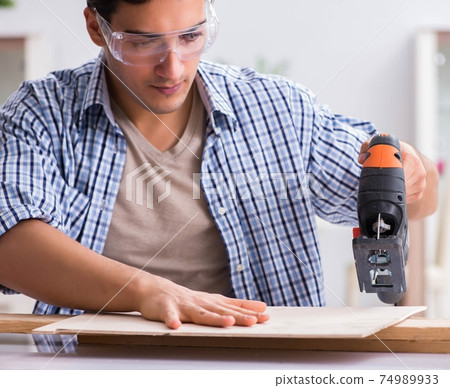 Young man in woodworking hobby concept 74989933