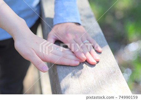 Newlyweds piling up hands Newlyweds piling up hands 74990159