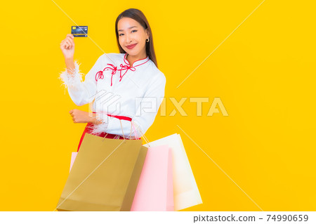 Portrait beautiful young asian woman with shopping bag and credit card Portrait beautiful young asian woman with shopping bag and credit card 74990659