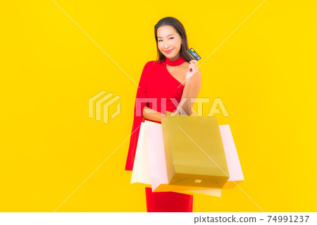 Portrait beautiful young asian woman with shopping bag and credit card Portrait beautiful young asian woman with shopping bag and credit card 74991237