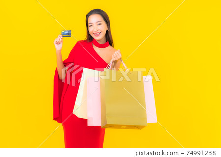 Portrait beautiful young asian woman with shopping bag and credit card Portrait beautiful young asian woman with shopping bag and credit card 74991238