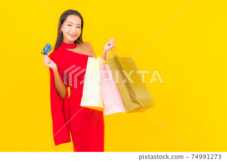 Portrait beautiful young asian woman with shopping bag and credit card Portrait beautiful young asian woman with shopping bag and credit card 74991273