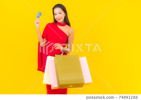 Portrait beautiful young asian woman with shopping bag and credit card Portrait beautiful young asian woman with shopping bag and credit card 74991288