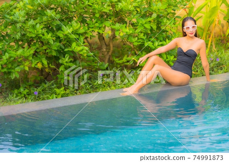 Portrait beautiful young asian woman enjoy relax around swimming pool 74991873