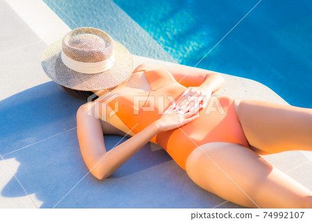 Portrait beautiful young asian woman enjoy relax around swimming pool Portrait beautiful young asian woman enjoy relax around swimming pool 74992107